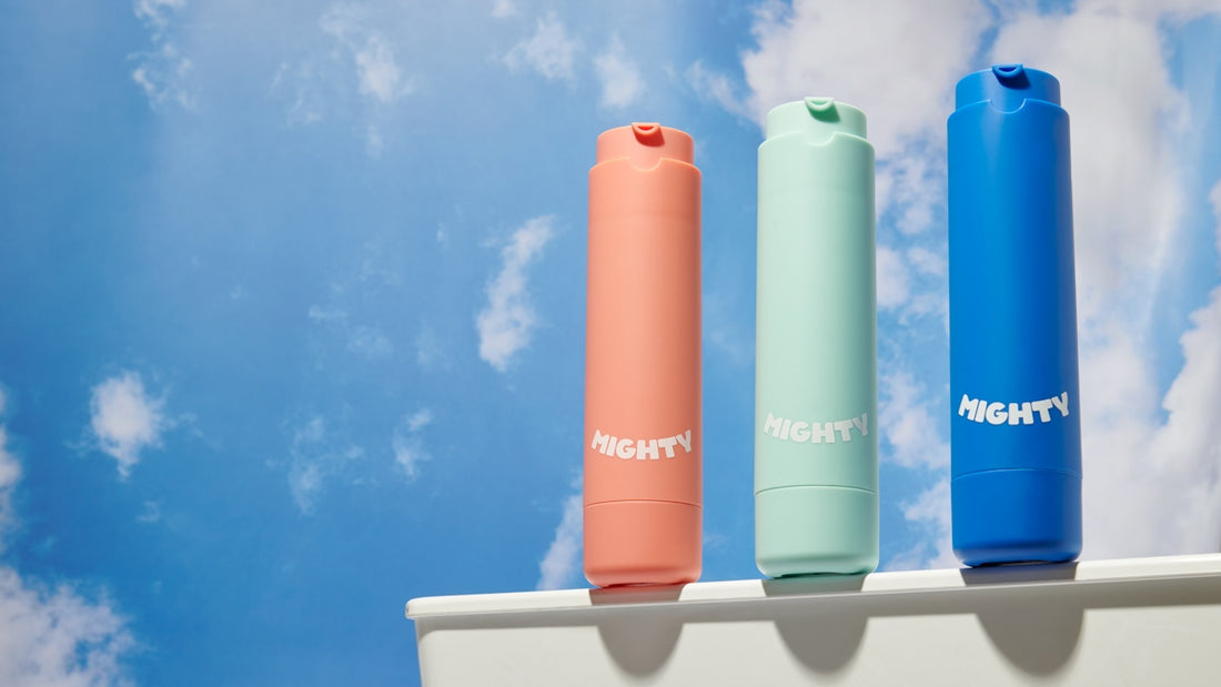 Three colorful lipsticks on a shelf with clouds